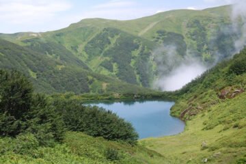 A scenic view of Kintrishi National Park in Georgia's Adjara region, featuring lush forests, mountains, and the Kintrishi River